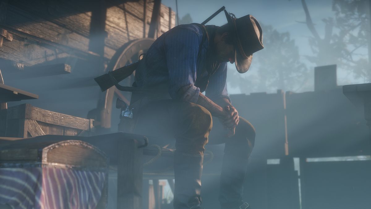 Red Dead Redemption 2 - Arthur sits by his wagon, contemplating what he has done