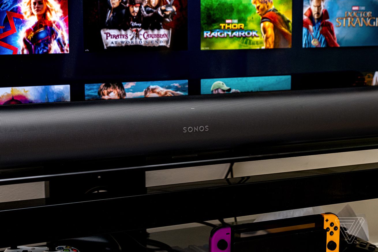An image of the front of the Sonos Arc soundbar with a TV in the background.