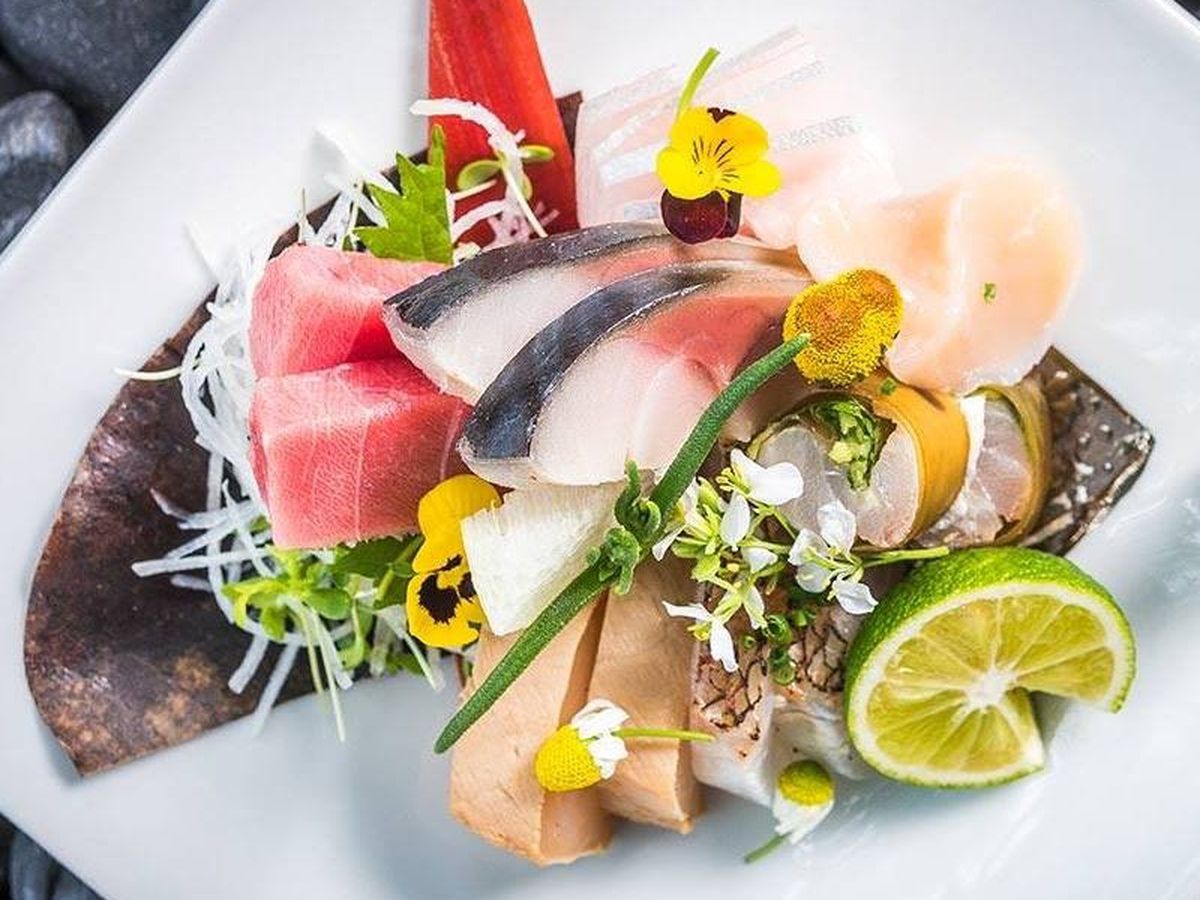A beautiful spread of raw fish with garnishes.