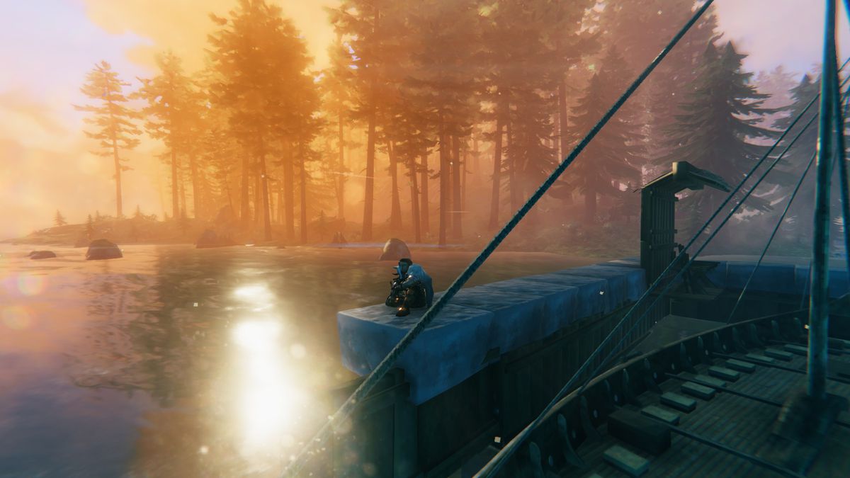 A player sits by the water, enjoying the reflection of the sun on the lake