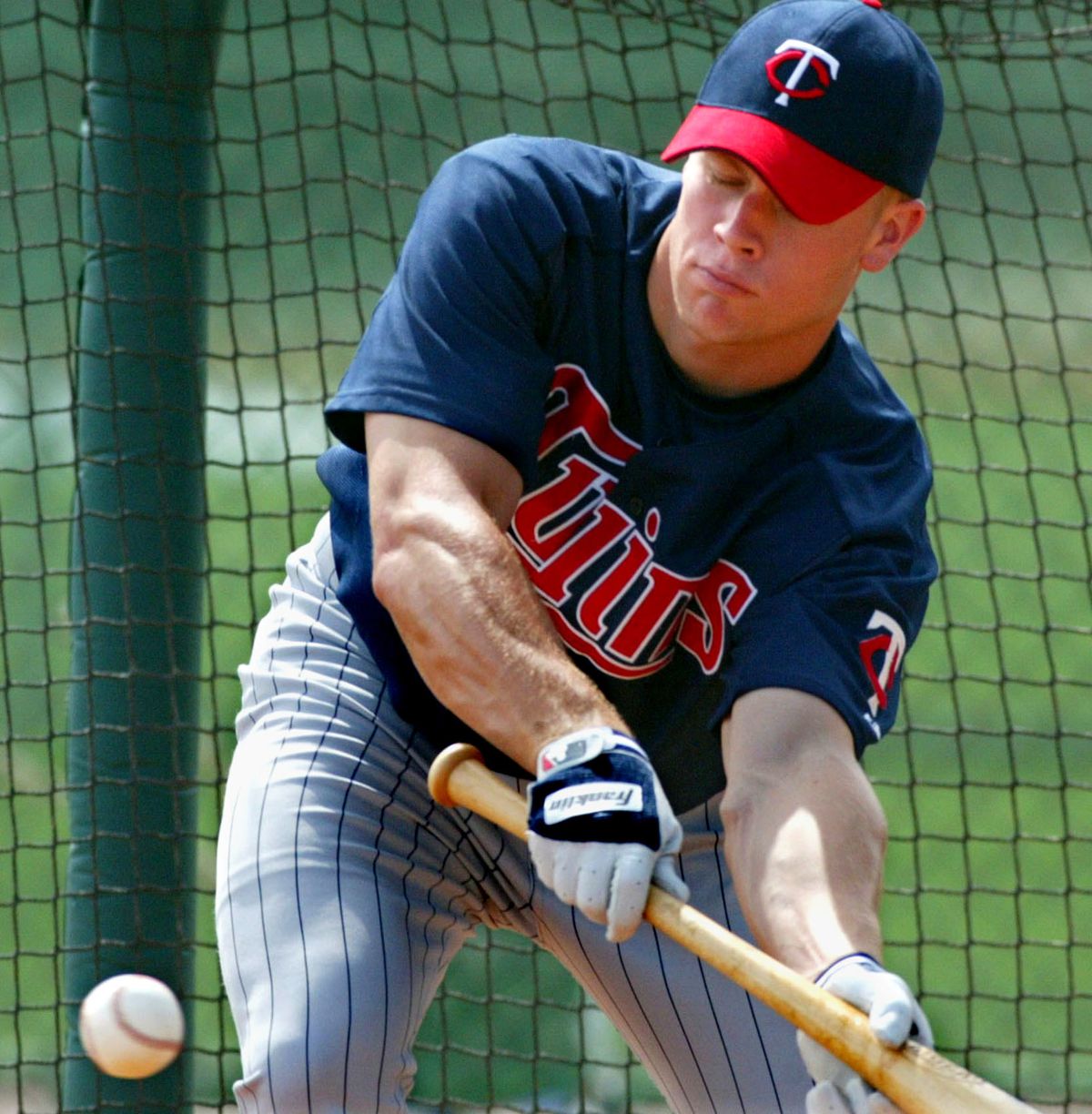 Justin Morneau (shown here) — Ft. Myers, Fla - Twins Spring Training - For Sunday, March 2, 2003 - For the first time, big money contracts and rising young talent may be chipping away at the Twins happy family atmosphere. Justin Morneau, shown here bunt