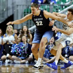 San Diego Toreros center Jake Gilliam (32) pushes Brigham Young Cougars forward Gavin Baxter (25) away as the BYU Cougars and San Diego Toreros play in WCC tournament action at the Orleans Arena in Las Vegas on Saturday, March 9, 2019. San Diego won 80-57.