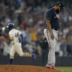 SEATTLE, WASHINGTON - SEPTEMBER 11: Kenley Jansen #74 of the Atlanta Braves reacts after giving up a home run to Julio Rodriguez #44 of the Seattle Mariners during the ninth inning at T-Mobile Park on September 11, 2022 in Seattle, Washington.