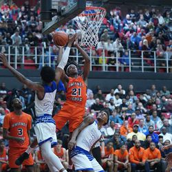 Young’s DJ Steward (21) makes a hard basket over Curie’s Justin Harmon (24)Friday 03-08-19. Worsom Robinson/For the Sun-Times.