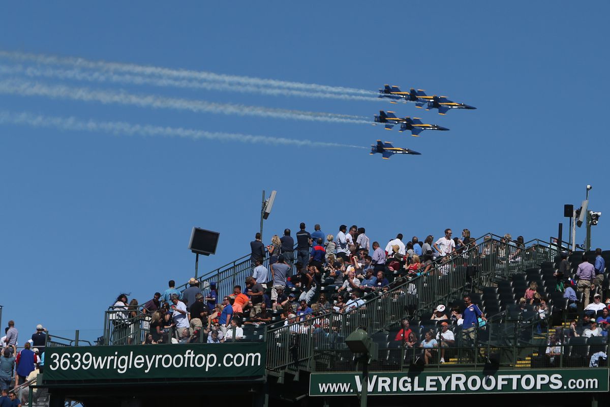 Rooftop fans, as were many others, were more interested in the air show than the game Thursday.