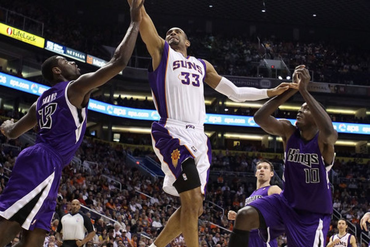 Grant Hill #13 of the Phoenix Suns lays up a shot past Tyreke Evans #13 and Samuel Dalembert #10 of the Sacramento Kings during the NBA game at US Airways Center on February 13 2011 in Phoenix Arizona.  (Photo by Christian Petersen/Getty Images)