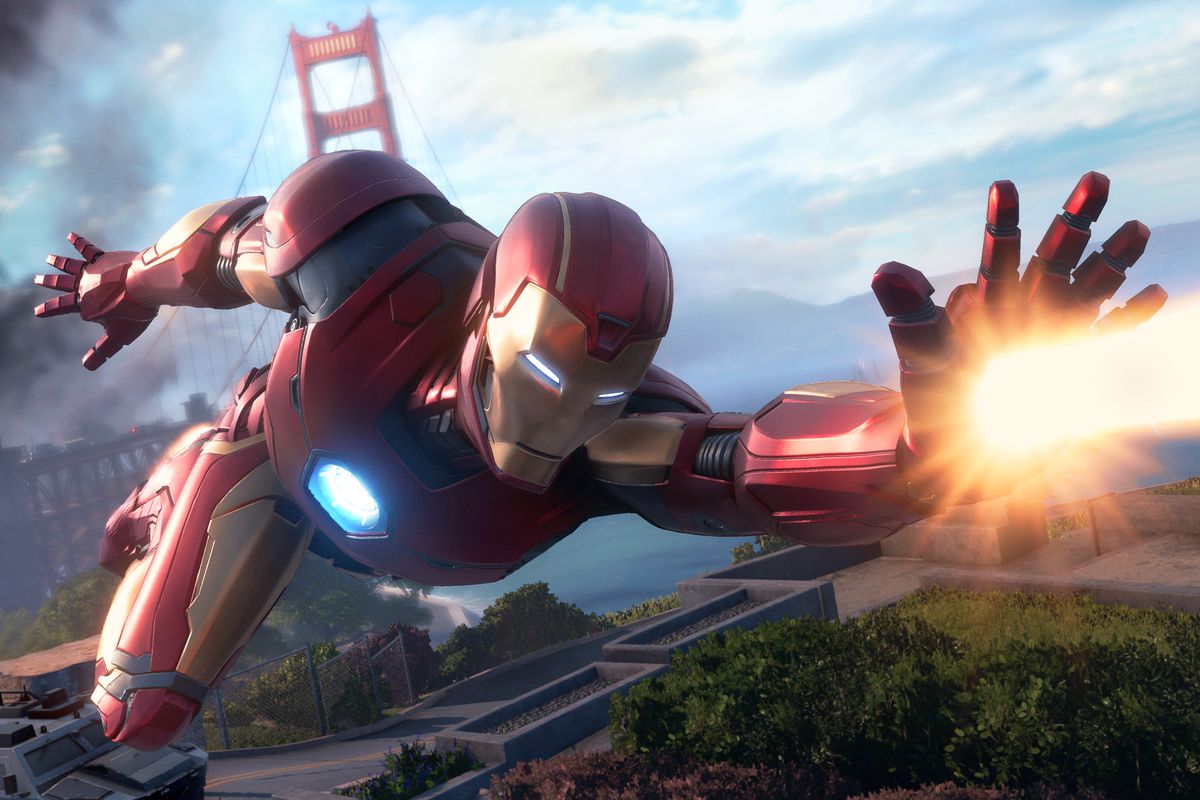 Iron Man flying with the Golden Gate Bridge in the background and firing a beam from his left hand in Marvel’s Avengers