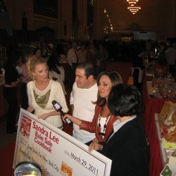 Sandra Lee, Emeril, and Rosanna Scotto presented a check for $25,000 to the Food Bank of New York City but anticipated raising a total of at least $50,000 with the aid of 30 NYC-based chefs and bakeries selling treats for the cause.