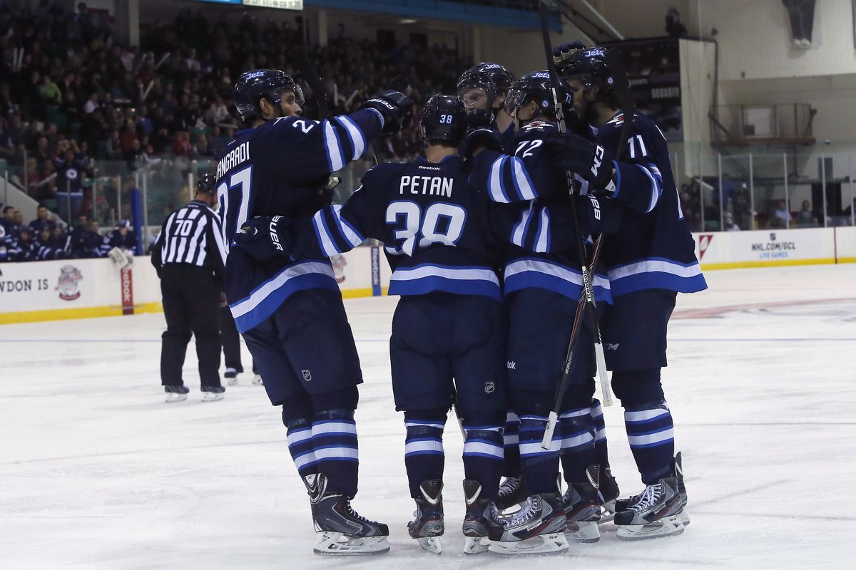 Jets prospect Nic Petan celebrating with the team during the preseason.