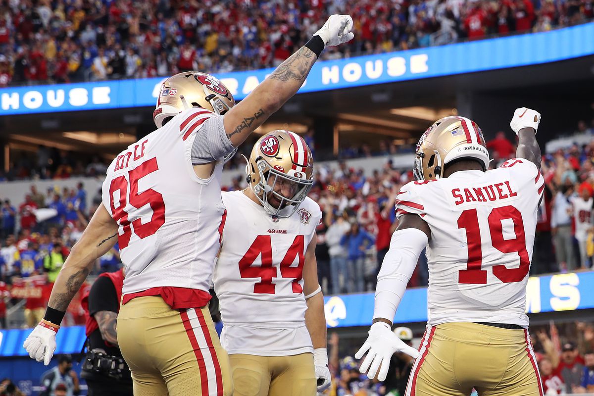 Deebo Samuel #19 of the San Francisco 49ers reacts with teammates Kyle Juszczyk #44 and George Kittle #85 after scoring a touchdown in the second quarter against the Los Angeles Rams in the NFC Championship Game at SoFi Stadium on January 30, 2022 in Inglewood, California.