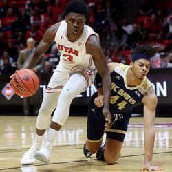 Utah Utes forward Donnie Tillman (3) drives into the lane as UC Davis Aggies forward Garrison Goode (44) falls to the floor as Utah and UC Davis play in an NIT basketball game at the Huntsman Center in Salt Lake City on Wednesday, March 14, 2018. Utah won 69-59.