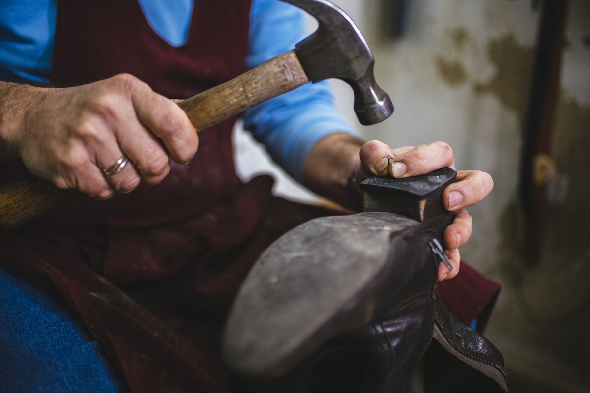 A cobbler fixing a shoe