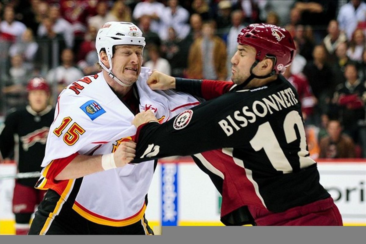 Mar 1., 2012; Glendale, AZ, USA; Calgary Flames right wing Tim Jackman (15) is punched by Phoenix Coyotes left wing Paul Bissonnette (12) during the second period at Jobing.com Arena. Mandatory Credit: Matt Kartozian-US PRESSWIRE