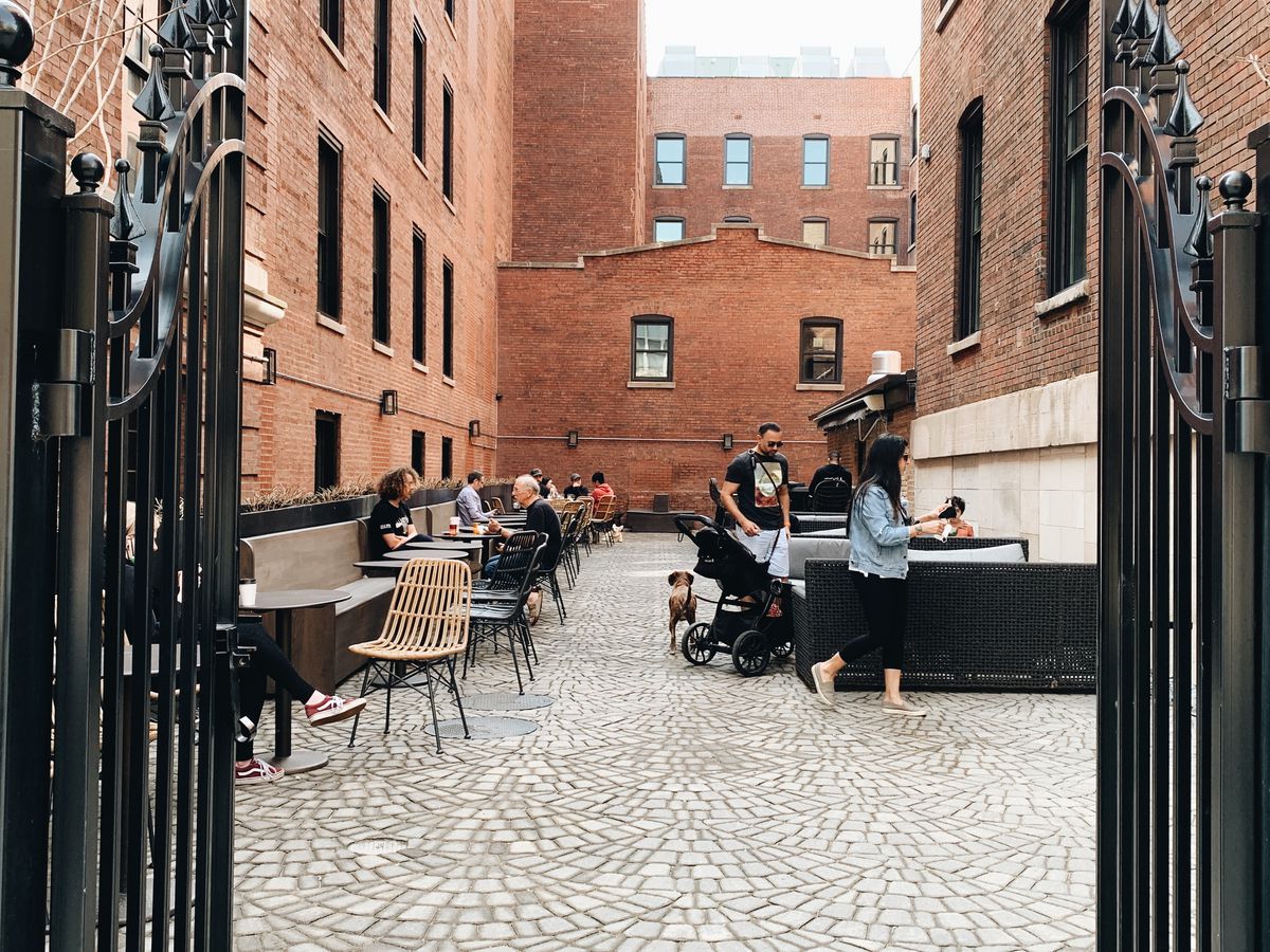 A cobblestone alleyway with tables.