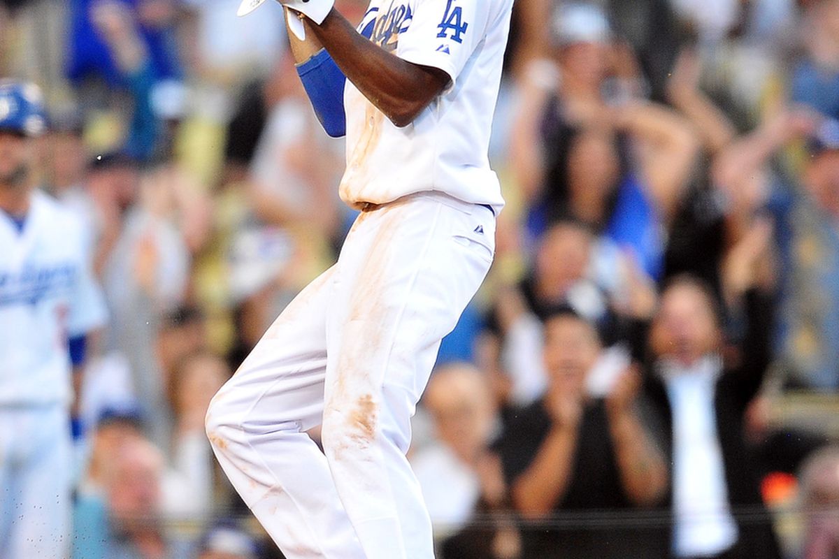 July 1, 2012; Los Angeles, CA, USA; Los Angeles Dodgers shortstop Dee Gordon (9) reacts after scoring in the seventh inning against the New York Mets at Dodger Stadium. Mandatory Credit: Gary A. Vasquez-US PRESSWIRE
