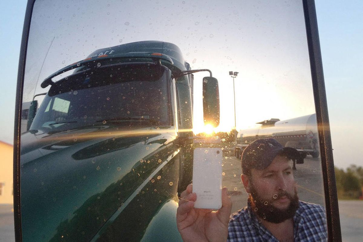 This undated image provided by James Weitze shows a truck driver taking a self portrait on the road. Weitze satisfies his video fix with an iPhone. He sleeps most of the time in his truck, and has no apartment. To be sure, he's an extreme case and probabl