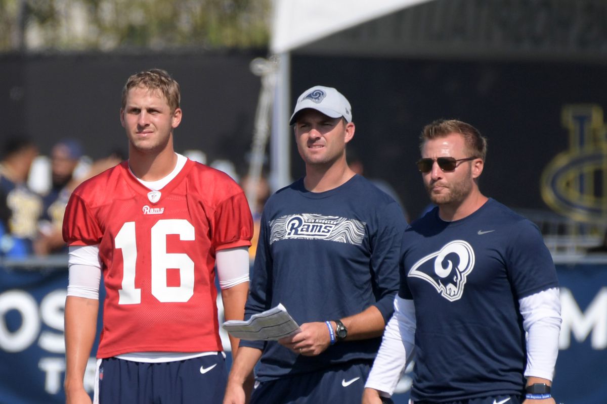 Los Angeles Rams quarterback Jared Goff, quarterbacks coach Zac Taylor and coach Sean McVay react during training camp at UC Irvine.