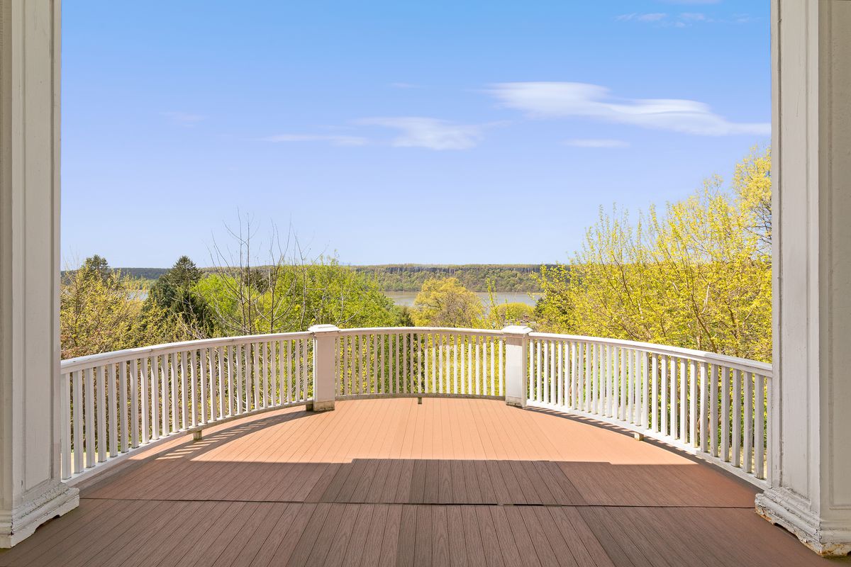 Curved deck with views of a river and foliage.