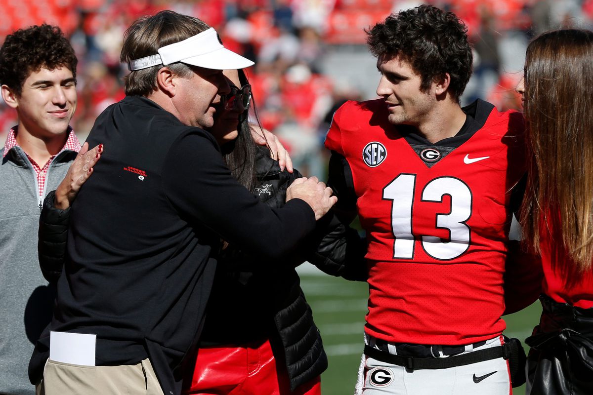 Georgia coach Kirby Smart speaks with Georgia quarterback Stetson Bennett during senior day photos before a NCAA college football game between Charleston Southern and Georgia in Athens, Ga., on Saturday, Nov. 20, 2021.&nbsp;