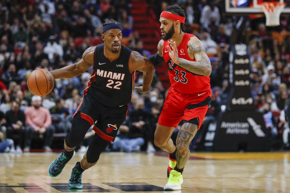 Miami Heat forward Jimmy Butler (22) dribbles the basketball as Toronto Raptors guard Gary Trent Jr. (33) defends during the second quarter at FTX Arena.