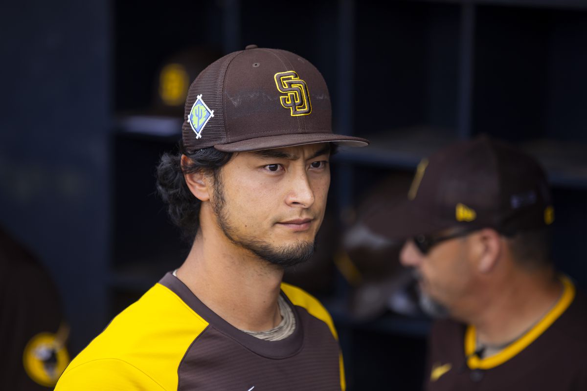 Yu Darvish stares into the distance in the Padres dugout
