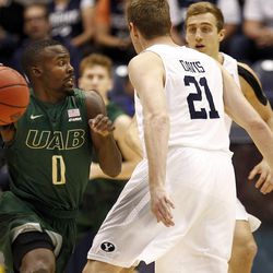 UAB Blazers guard Hakeem Baxter (0) tries to dribble around Brigham Young Cougars forward Kyle Davis (21) during the first round of the NIT at the Marriott Center in Provo, Wednesday, March 16, 2016.