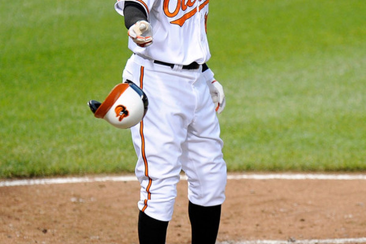 BALTIMORE, MD - JUNE 28:  Adam Jones #10 of the Baltimore Orioles tosses his helmet after striking out against the Cleveland Indians at Oriole Park at Camden Yards on June 28, 2012 in Baltimore, Maryland.  (Photo by Greg Fiume/Getty Images)