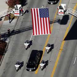 The funeral procession for West Valley police officer Cody Brotherson moves toward the cemetery in West Valley City on Monday, Nov. 14, 2016. Officer Brotherson was killed while trying to help stop a fleeing car during a chase on Nov. 6, 2016.