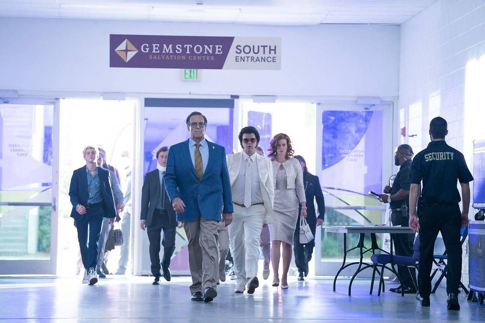 Eli Gemstone (John Goodman) and his famil walk into the Gemstone Salvation Center, which looks kind of like a school or hospital entrance, complete with security guards, in The Righteous Gemstones season 3.