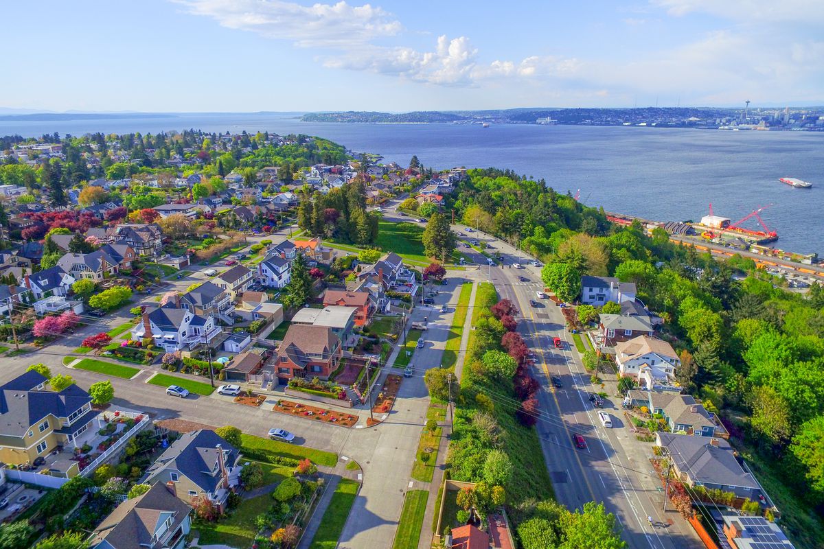 An aerial view of West Seattle and the Puget Sound waterfront on a clear, sunny day.