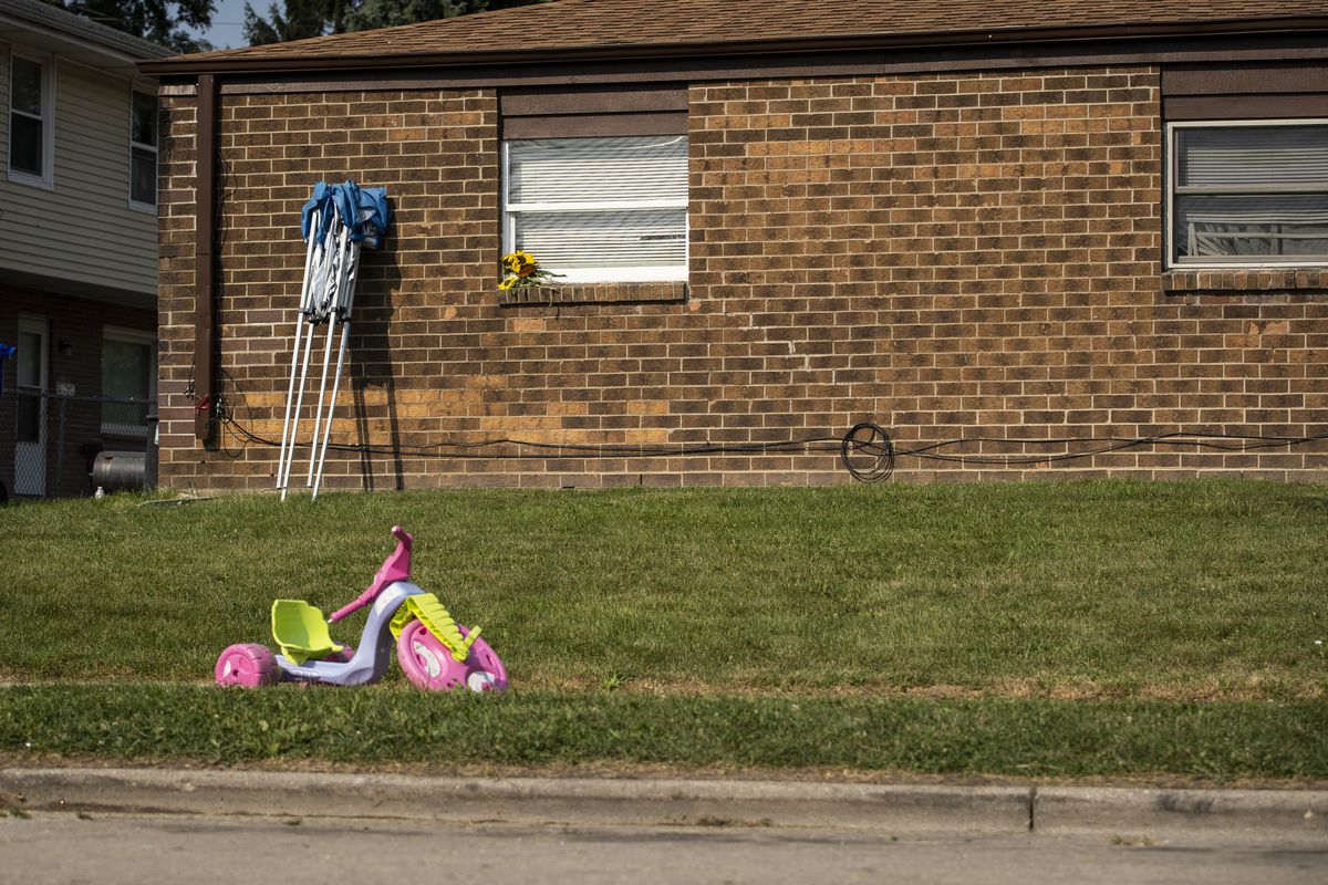 A tricycle and flowers can be seen Monday where Kenosha police shot Jacob Blake a day earlier.