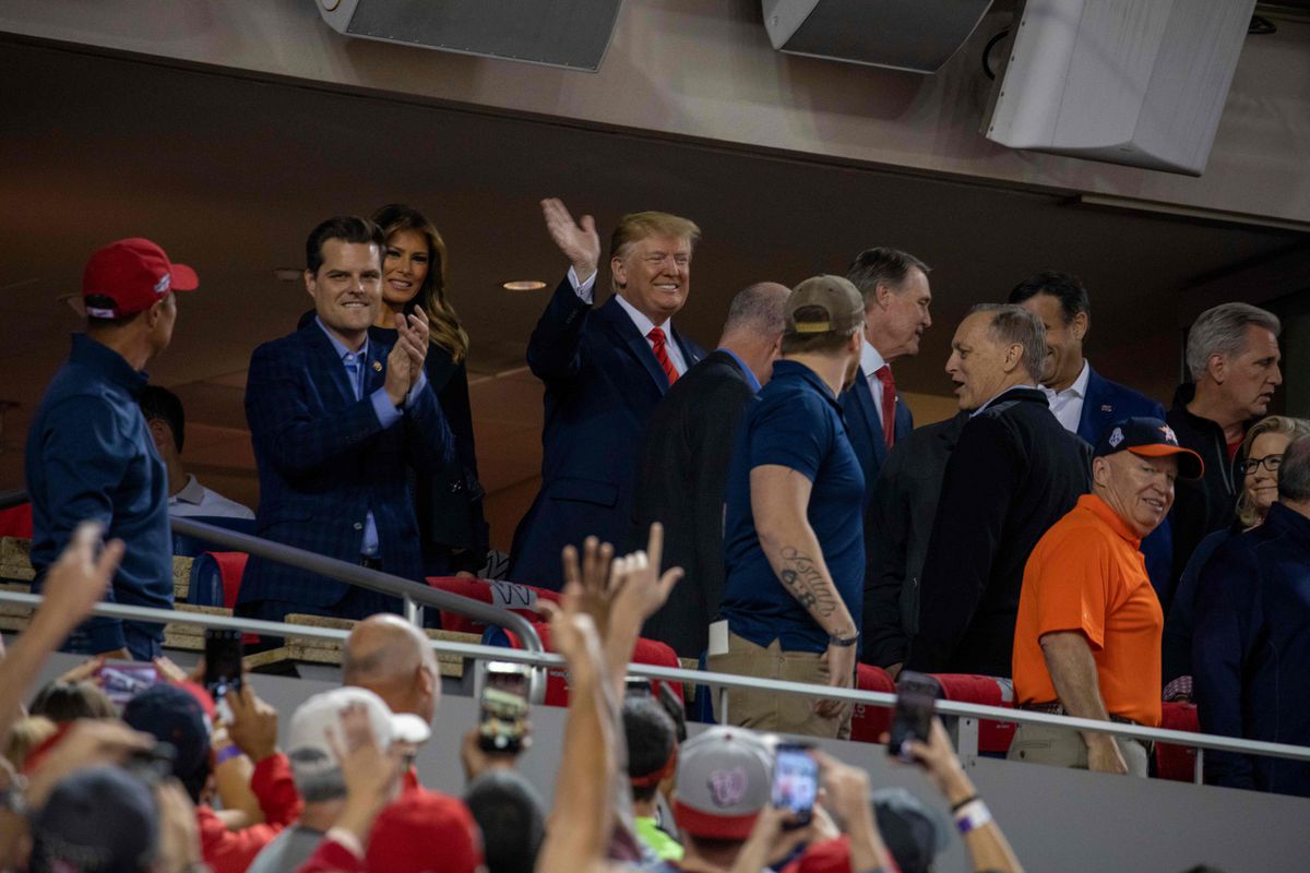 US President Donald Trump waves as US First Lady Melania Trump (2L) looks on as they attend Game 5 of the World Series between the Washington Nationals and Houston Astros at Nationals Park in Washington, DC on October 27, 2019. (Photo by TASOS KATOPODIS / AFP) (Photo by TASOS KATOPODIS/AFP via Getty Images)
