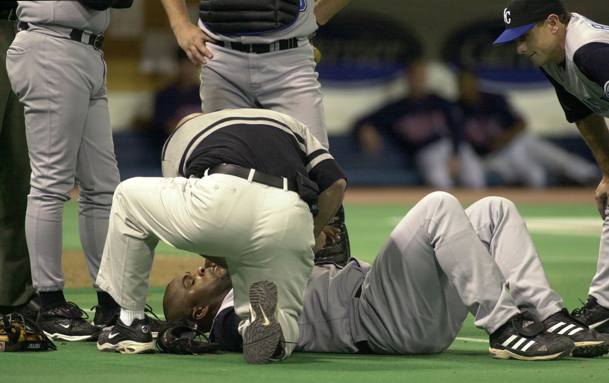 Minneapolis, Mn., Thurs., May 15, 2003—Kansas City Royals first baseman Ken Harvey was helped out by teammates and staff after he fell after trying to catch a ball. (I think he may have injured his wrist.) Later in the game he was hit by a pitch. GE