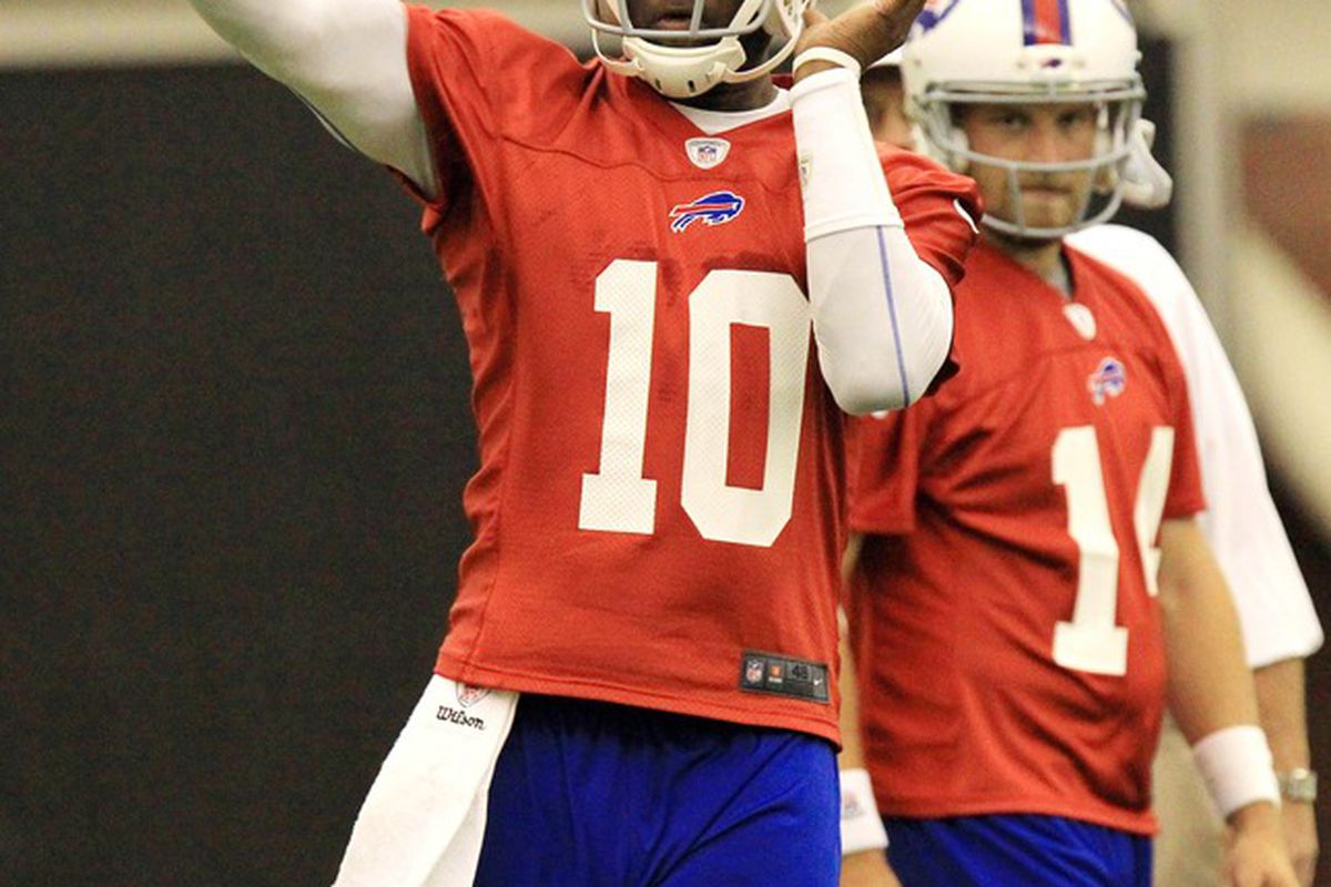 May 29, 2012; Orchard Park, NY, USA; Buffalo Bills quarterback Vince Young (10) passes as quarterback Ryan Fitzpatrick (14) watches during organized team activities at Ralph Wilson Field House. Mandatory Credit: Kevin Hoffman-US PRESSWIRE