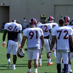 (L to R) Broncos defensive linemen DeMarcus Ware, Sione Fua, Hall Davis, and Terrance Knighton make their way to the next drill.