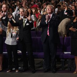 Republican presidential candidate Donald Trump, center, looks on during a church service at Great Faith Ministries, on Sept. 3, 2016, in Detroit.