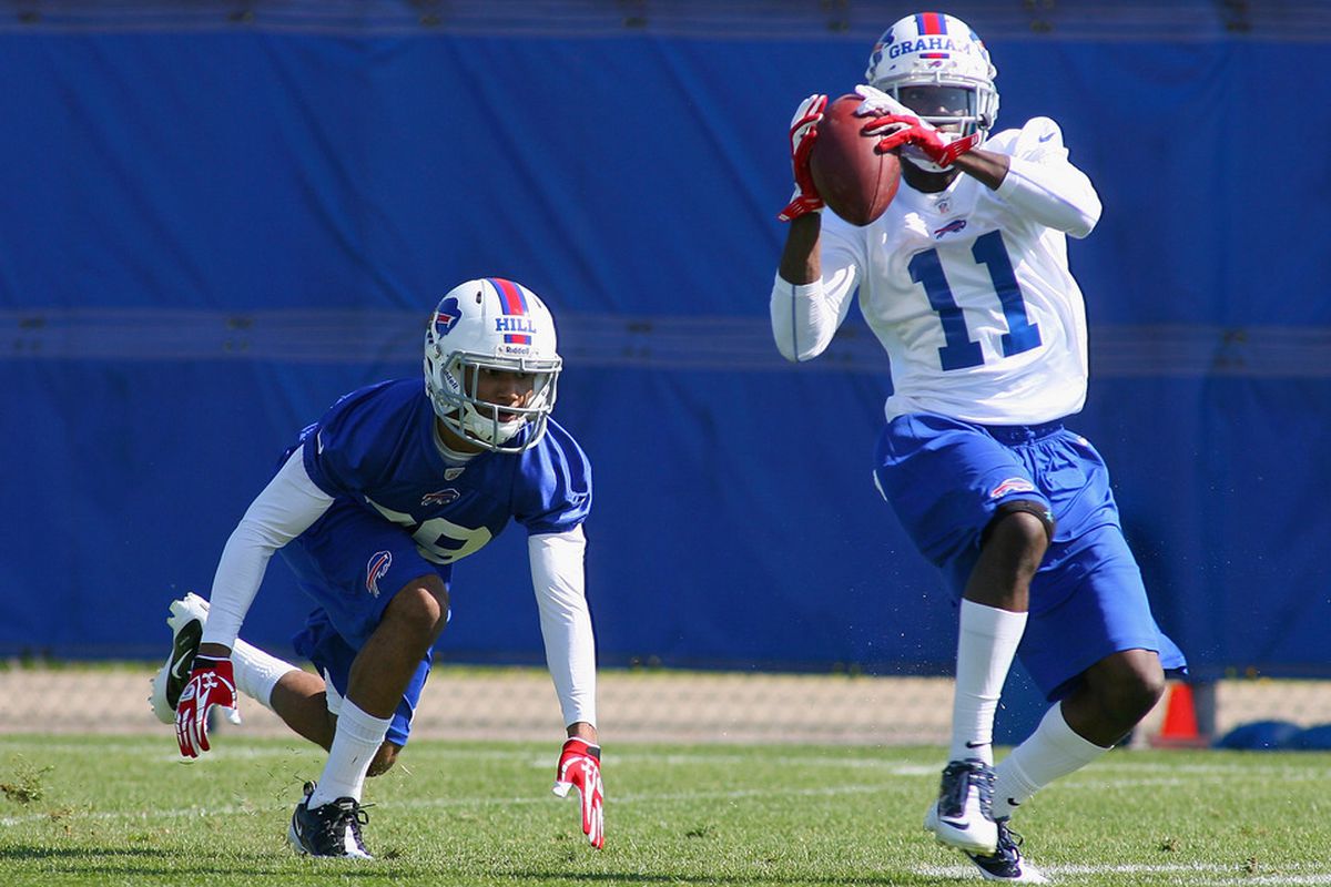 ORCHARD PARK, NY - MAY 11: T.J. Graham #11 of  the Buffalo Bills  makes a catch in front of Cris Hill #39  during  Buffalo Bills Rookie Camp on May 11, 2012 in Orchard Park, New York.  (Photo by Rick Stewart/Getty Images)