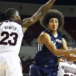 Utah State guard Jalen Moore (14) looks for an open shot as Mississippi State guard Travis Daniels (23) defends Saturday, Nov. 22, 2014, in Starkville, Mississippi. Mississippi State won, 71-63. 
