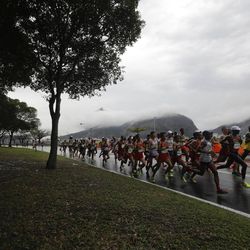 Athletes, including USA's Jared Ward, compete along the Guanabara bay and the Sugar Loaf mountain in the men's marathon at the 2016 Summer Olympics in Rio de Janeiro, Brazil, Sunday, Aug. 21, 2016.