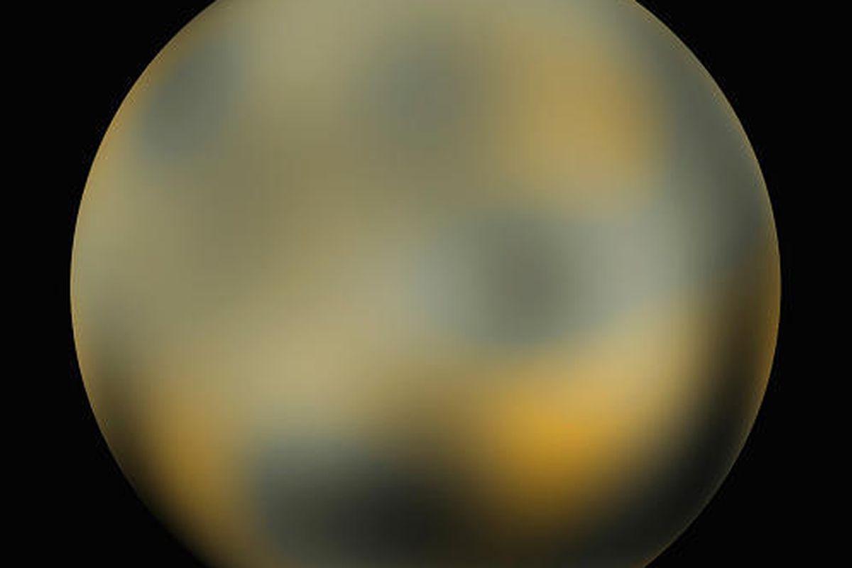 This undated handout photo provided by NASA, taken by NASA's Hubble Space Telescope, shows the dwarf planet Pluto.The image shows an icy, mottled, dark molasses-colored world undergoing seasonal surface color and brightness changes.