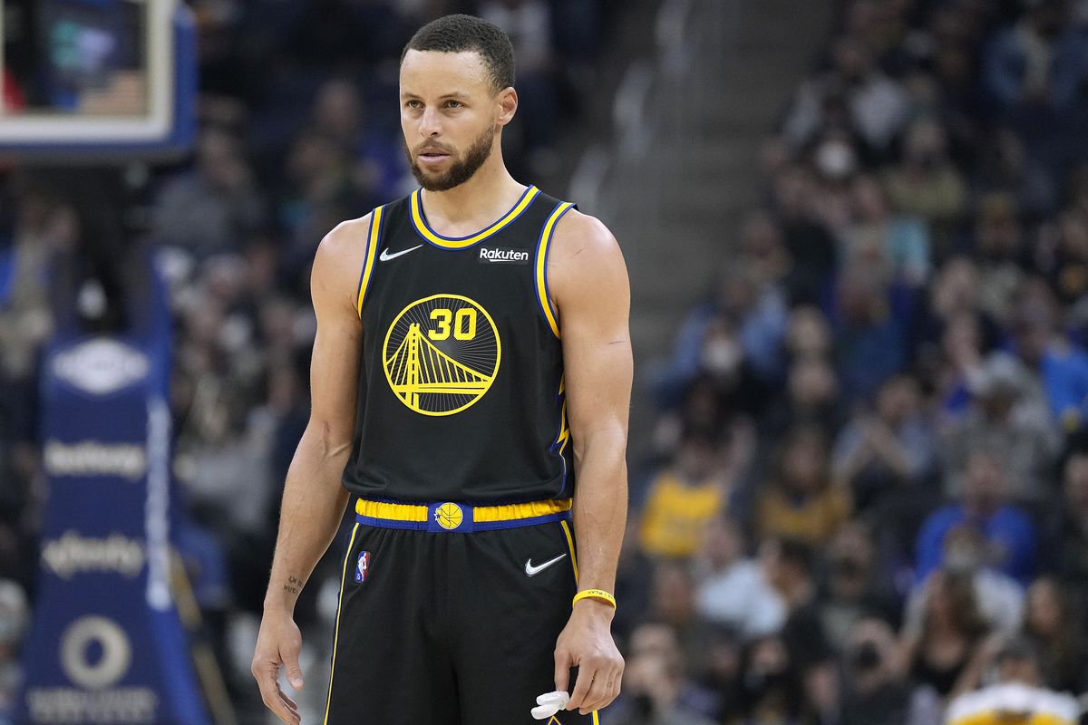Stephen Curry #30 of the Golden State Warriors looks on against the Denver Nuggets during the first half of an NBA basketball game at Chase Center on February 16, 2022 in San Francisco, California.