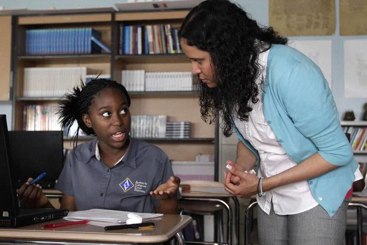 Student Mariatou Samou, left, speaks with her teacher, Kayla Morrow. Teacher preparation programs do not adequately prepare new teachers like Morrow for the rigors of the classroom, according to a new report from the National Coalition of Teacher Quality.