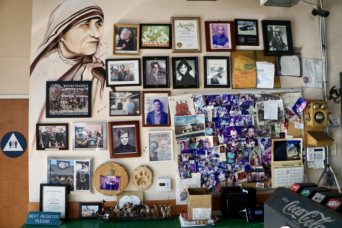 A wall of photographs and a mural of Mother Teresa at Ranch Side Cafe