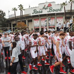 Members of he Utah Utes football team walk near the Rose Bowl after a team photo in Pasadena, Calif., on Thursday, Dec. 30, 2021.