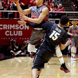 Utah Utes guard Brandon Taylor (11) crashes into Colorado Buffaloes guard Dominique Collier (15) at the University of Utah's Huntsman Center in Salt Lake City on Saturday, March 5, 2016.  