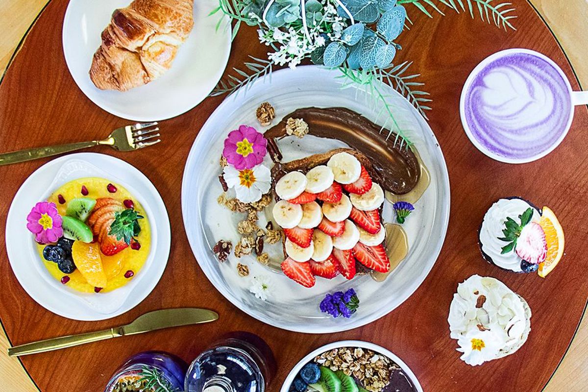 A spread of bowls and salads with edible flowers