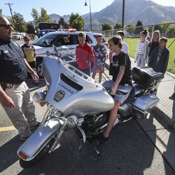 J. Cardenas, Unified Police student resource officer for Olympus Junior High School, shows seventh grade students in the career technical education class a Unified Police motorcycle during Vehicle Day in Holladay on Wednesday, Sept. 25, 2019. During the day students learned about different careers and the vehicles that go along with them.
