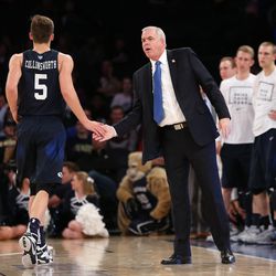 Brigham Young Cougars guard Kyle Collinsworth (5) fives Brigham Young Cougars head coach Dave Rose as he comes out of the ball game as BYU and Valparaiso play in NIT Semifinal action at Madison Square Garden in New York City. BYU loses 70-72 Tuesday, March 29, 2016.