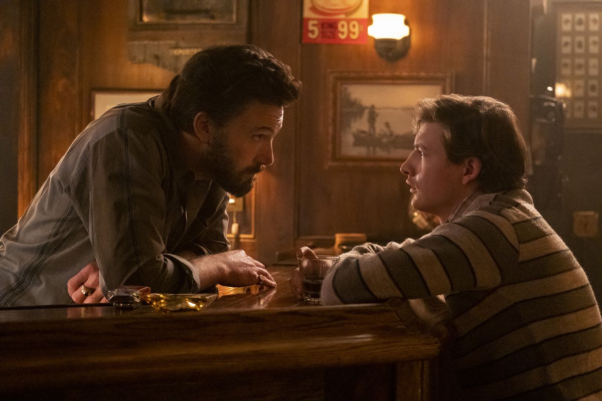Saloon owner Charlie (Ben Affleck, left) acts as a father figure for J.R. (Tye Sheridan) in “The Tender Bar.”