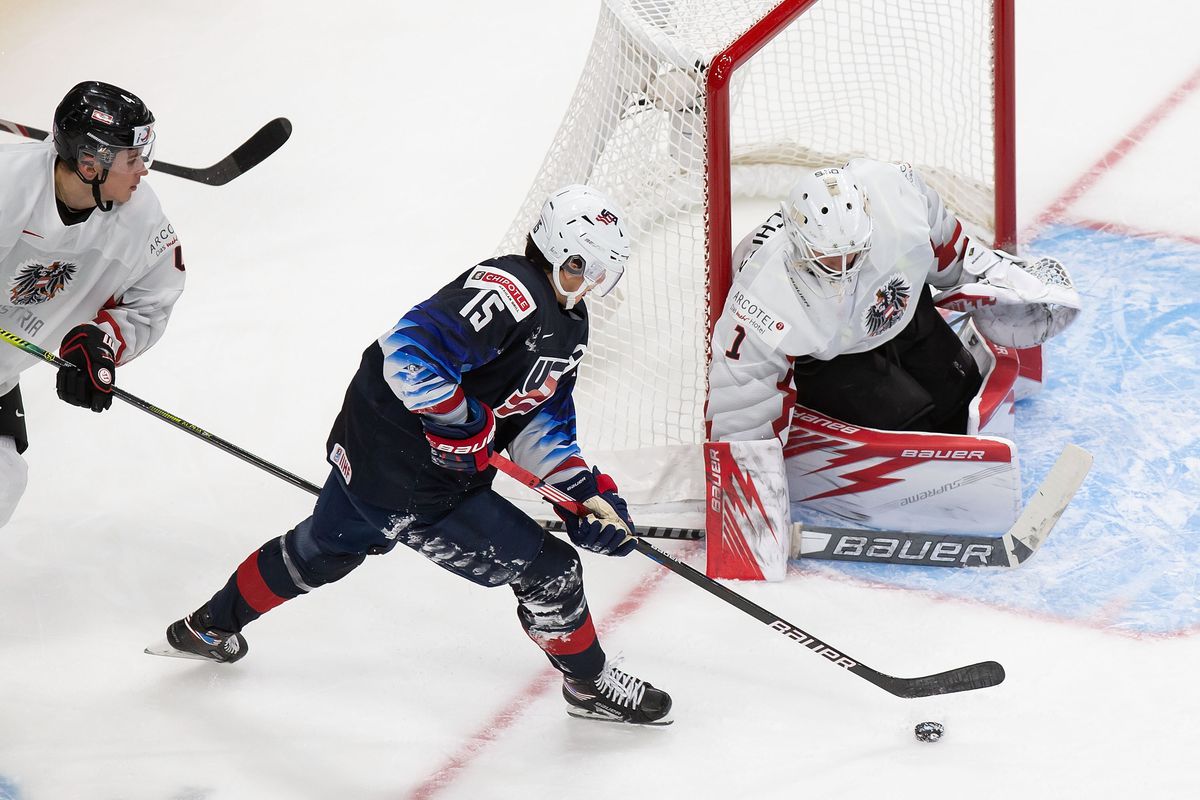 Alex Turcotte #15 of the United States looks for a shot against goaltender Sebastian Wraneschitz #1 of Austria during the 2021 IIHF World Junior Championship at Rogers Place on December 26, 2020 in Edmonton, Canada.